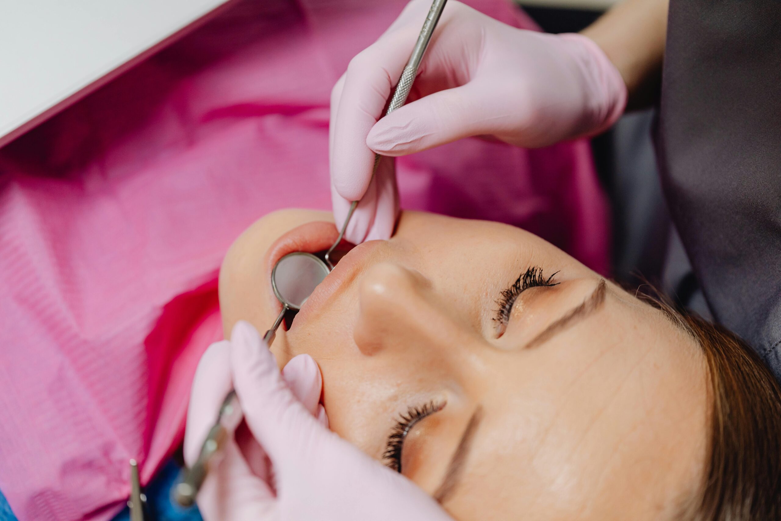 Close-up of a dentist performing a dental examination on a patient.